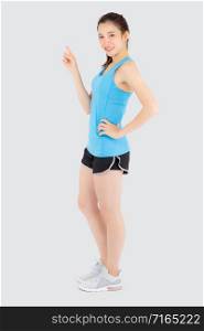 Beautiful portrait young asian woman in sport workout confident pointing and presenting and show something isolated on white background, asia girl exercise for fit with health and wellness concept.