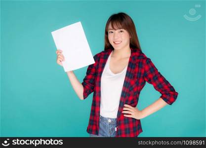Beautiful portrait young asian woman presenting with blank paper sheet, beauty asia girl wear travel summer fashion with happy showing empty board or card isolated on blue background.