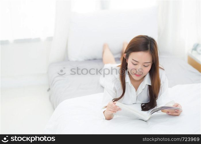 Beautiful portrait young asian woman relax lying reading book on bedroom in morning at home, girl study literature, education and lifestyle concept.