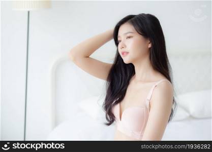 Beautiful portrait young asian woman sexy in underwear figure fit relax with seductive in bedroom, beauty asia girl body slim in lingerie confident and happy stand in bedchamber, lifestyle concept.