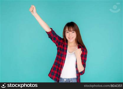 Beautiful portrait young asian woman smiling confident and excited summer holiday isolated blue background, beauty asia model girl enjoy and cheerful success with journey, travel concept.