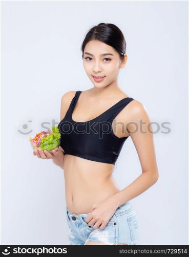 Beautiful portrait young asian woman smiling holding salad vegetable food isolated on white background, girl diet eating vegetarian for healthy, health care or wellness concept.