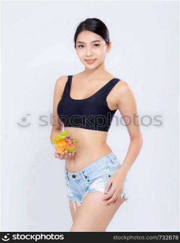 Beautiful portrait young asian woman smiling holding salad vegetable food isolated on white background, girl diet eating vegetarian for healthy, health care or wellness concept.