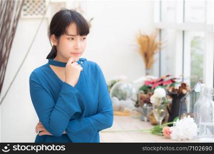 Beautiful portrait young asian woman smiling sitting at cafe, model girl happy with relax and resting looking camera, lifestyle concept.
