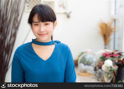 Beautiful portrait young asian woman smiling sitting at cafe, model girl happy with relax and resting looking camera, lifestyle concept.