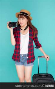 Beautiful portrait young asian woman standing with luggage smiling and travel summer trip for abroad in vacation, happy asia girl holding camera with suitcase for journey with cheerful in holiday.
