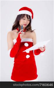 Beautiful portrait young asian woman thinking and writing notepad in xmas day isolated on white background, beauty asia girl think and list shopping or wish for celebrating in Christmas holiday.