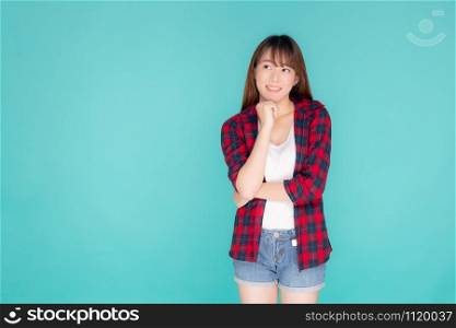 Beautiful portrait young asian woman wear clothes fashion travel thinking idea and enjoy summer holiday isolated blue background, girl smiling confident and cheerful, travel in vacation concept.