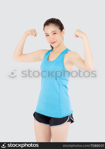 Beautiful portrait young asian woman wear sport clothes have strong and muscle with health, girl show biceps with exercise and workout for wellness isolated on white background, strength and fit concept.