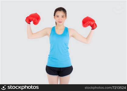 Beautiful portrait young asian woman wearing red boxing gloves flexing with strength and strength isolated on white background, asia girl workout exercise is sport training with punch, health concept.
