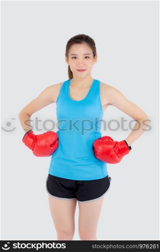 Beautiful portrait young asian woman wearing red boxing gloves with strength and strength isolated on white background, girl workout exercise is sport training with punch, health concept.