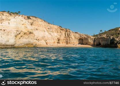 Beautiful Praia do Carvalho beach with golden rock cliffs, Portugal