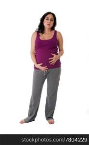 Beautiful pregnant Caucasian brunette woman holding her belly with an uncomfortable expression. Pregnancy contraction pains, isolated.