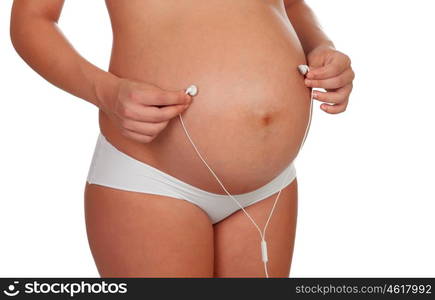 Beautiful pregnant listening to music isolated on a white background