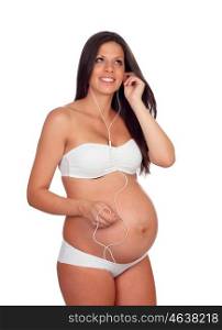 Beautiful pregnant listening to music isolated on a white background