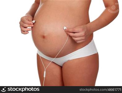 Beautiful pregnant listening to music isolated on a white background