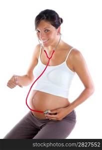 Beautiful pregnant woman as self doctor with stethoscope checking her belly