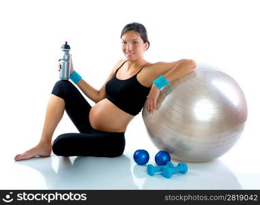 Beautiful pregnant woman at fitness gym relaxed with aerobics ball