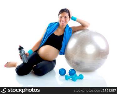 Beautiful pregnant woman at fitness gym relaxed with aerobics ball