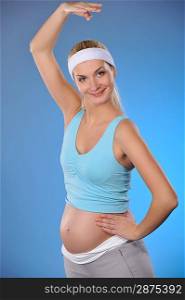 Beautiful pregnant woman doing fitness exercise