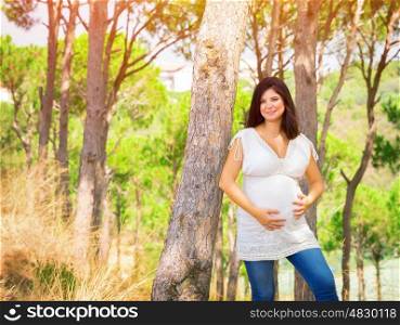 Beautiful pregnant woman having fun in summer park, young female expecting for a baby, happy motherhood, love concept