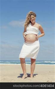 Beautiful pregnant woman in the beach