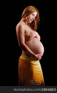 beautiful pregnant woman isolated on black