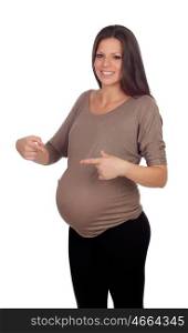Beautiful pregnant woman pointing her belly isolated on a white background