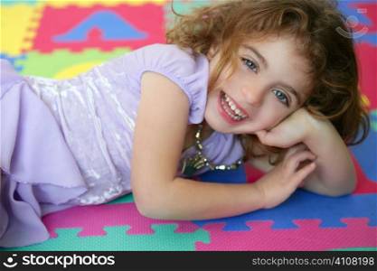 Beautiful princess little girl smiling lying on the floor