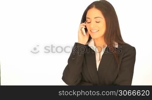 Beautiful professional brunette businesswoman using her mobile phone on a white background