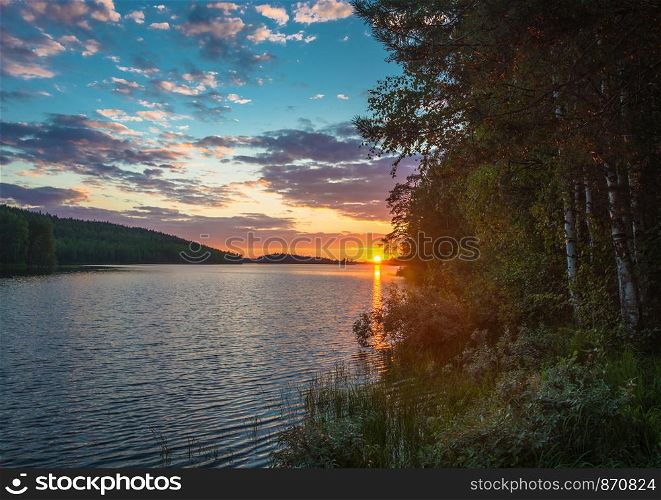 Beautiful purple sunset on a small lake in Karelia, Russia.