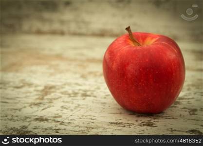 Beautiful red apple on a wooden background