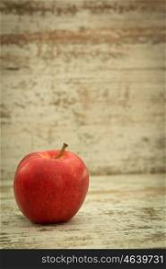 Beautiful red apple on a wooden background