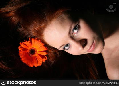 beautiful red flower in girl hair