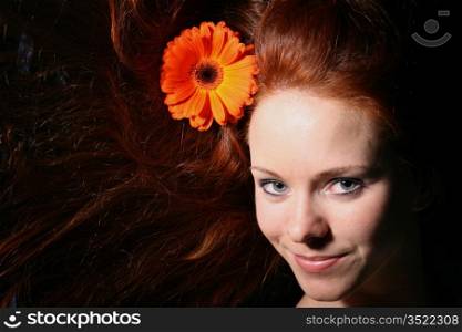 beautiful red flower in girl hair