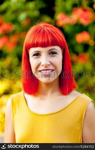 Beautiful red haired woman in a park lit with a golden light