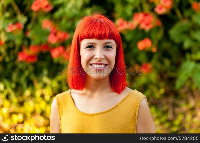 Beautiful red haired woman in a park lit with a golden light
