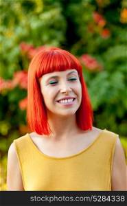 Beautiful red haired woman with the closed eyes in a park
