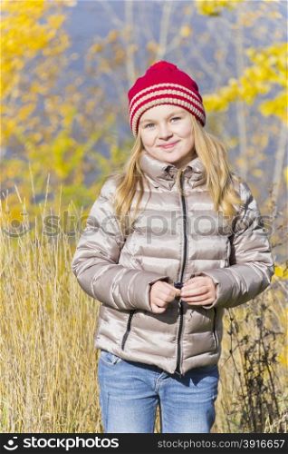 Beautiful Red Hat smiling girl in autumn