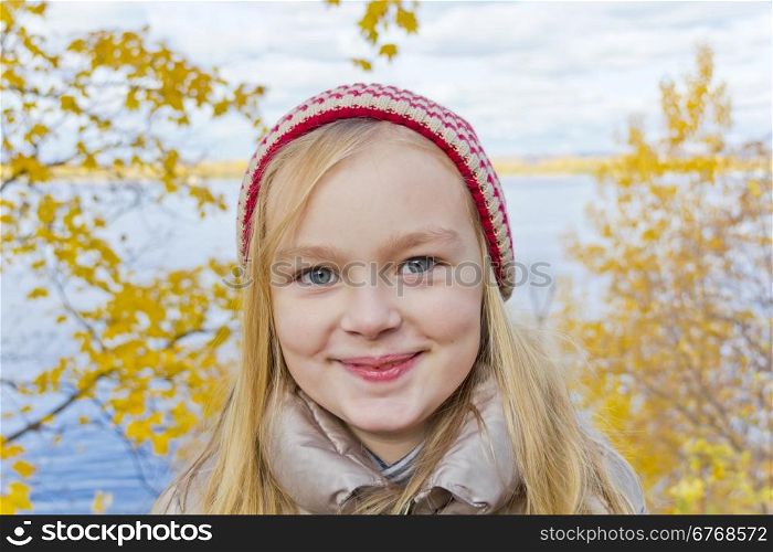 Beautiful Red Hat smiling girl on riverside