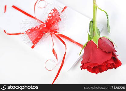 beautiful red rose and letter with ribbon close up