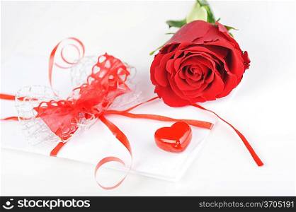 beautiful red rose and letter with ribbon close up