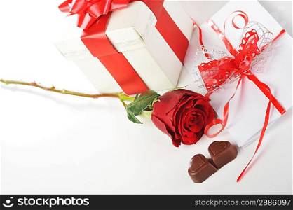 beautiful red rose, chocolate and letter on white