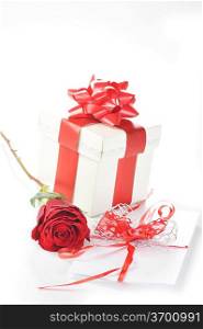 beautiful red rose, gift and letter close up