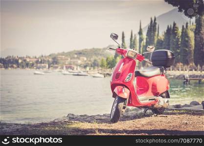 Beautiful red scooter on the beach, landscape and blue sky