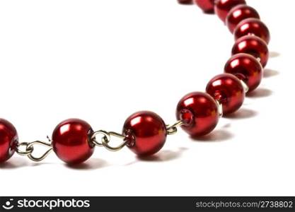 Beautiful red string of beads closeup on white background