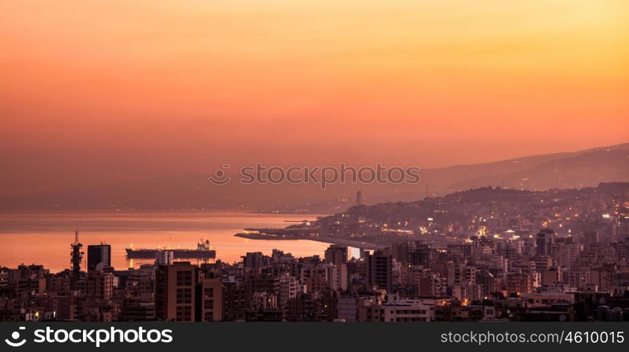 Beautiful red sunset on mountain city, evening cityscape, mediterranean sea, travel and tourism concept