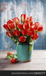 Beautiful red tulips bouquet on wooden table