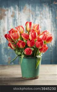 Beautiful red tulips bouquet on wooden table