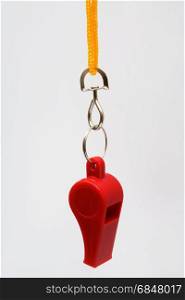 Beautiful red whistle on a yellow cord